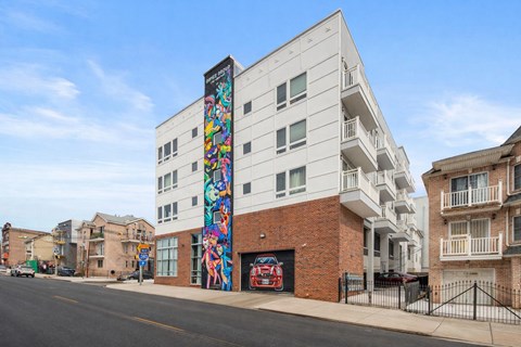 A white building with a colorful mural on the side.