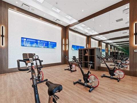 a gym with cardio equipment and exercise bikes