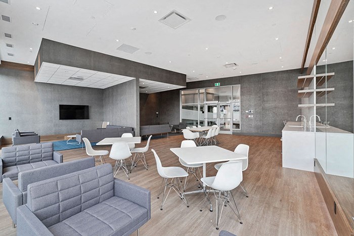 a lounge area with couches and tables and chairs