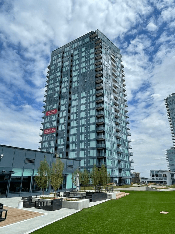 a tall building in a city with a blue sky