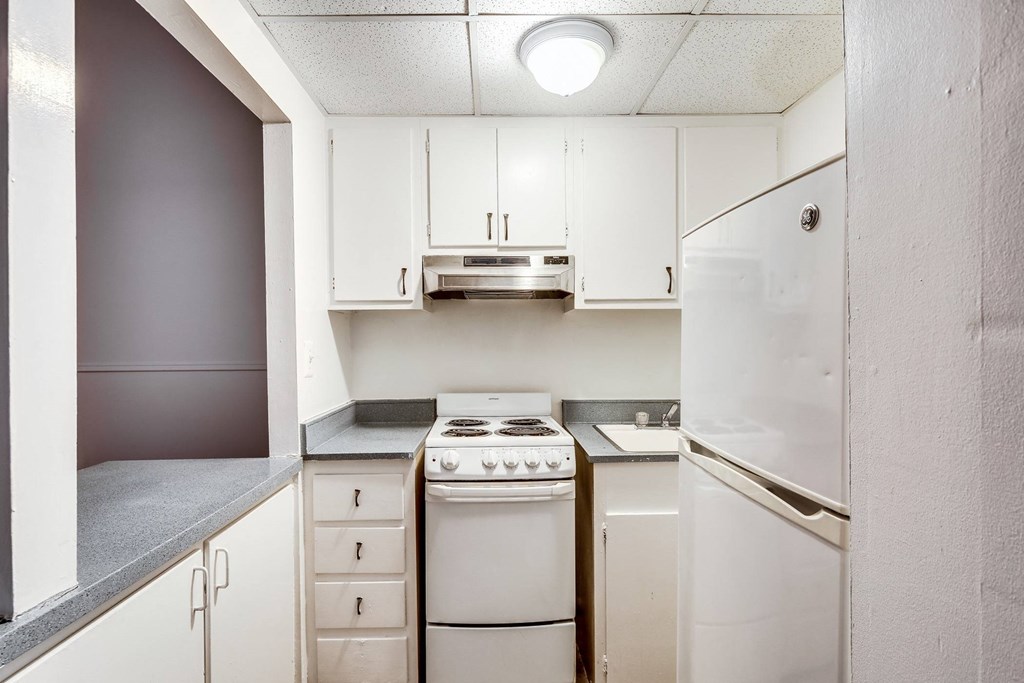 a white kitchen with white appliances and white cabinets