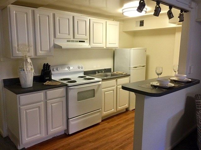 a kitchen with white appliances and white cabinets