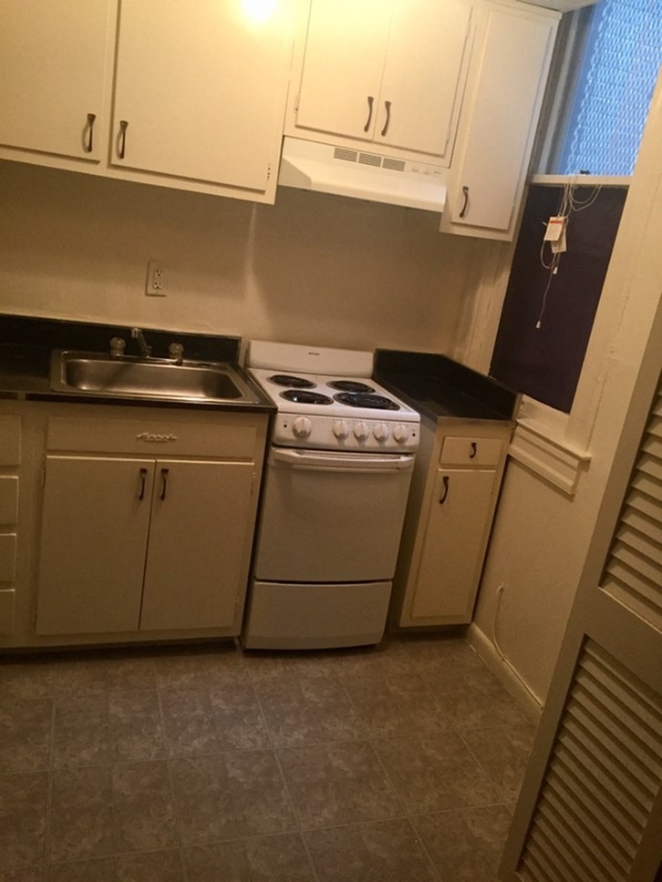 a kitchen with a stove and a sink