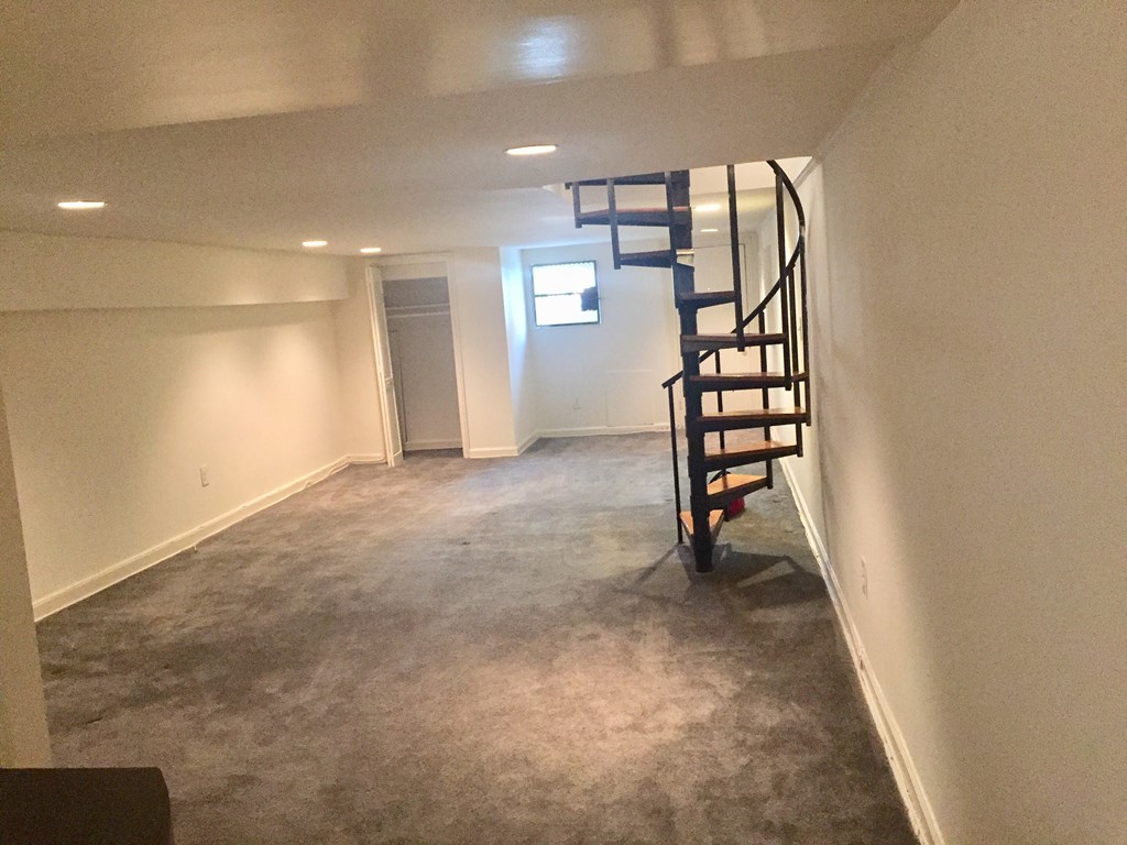 a small basement with a spiral staircase in the middle of it