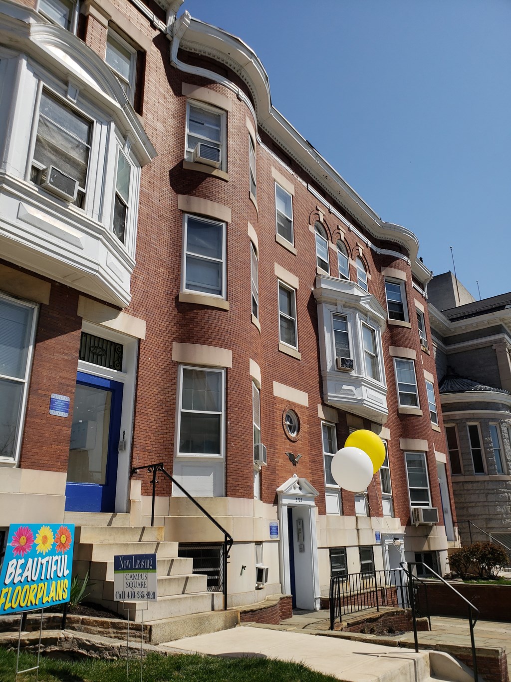a brick building with a balloon in front of it