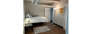 a bedroom with a bed and a lamp in it