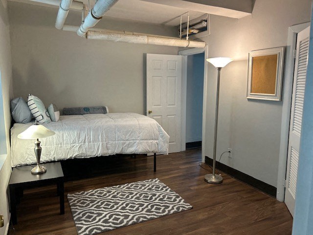 a bedroom with a bed and a lamp in it