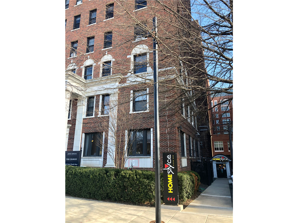 a building with a street sign in front of it