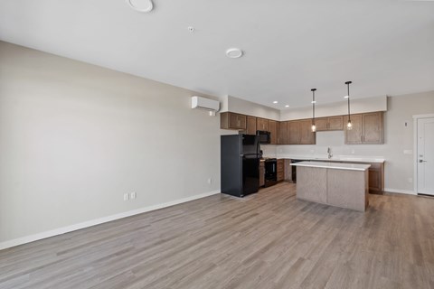 A kitchen with a black refrigerator and a white countertop.