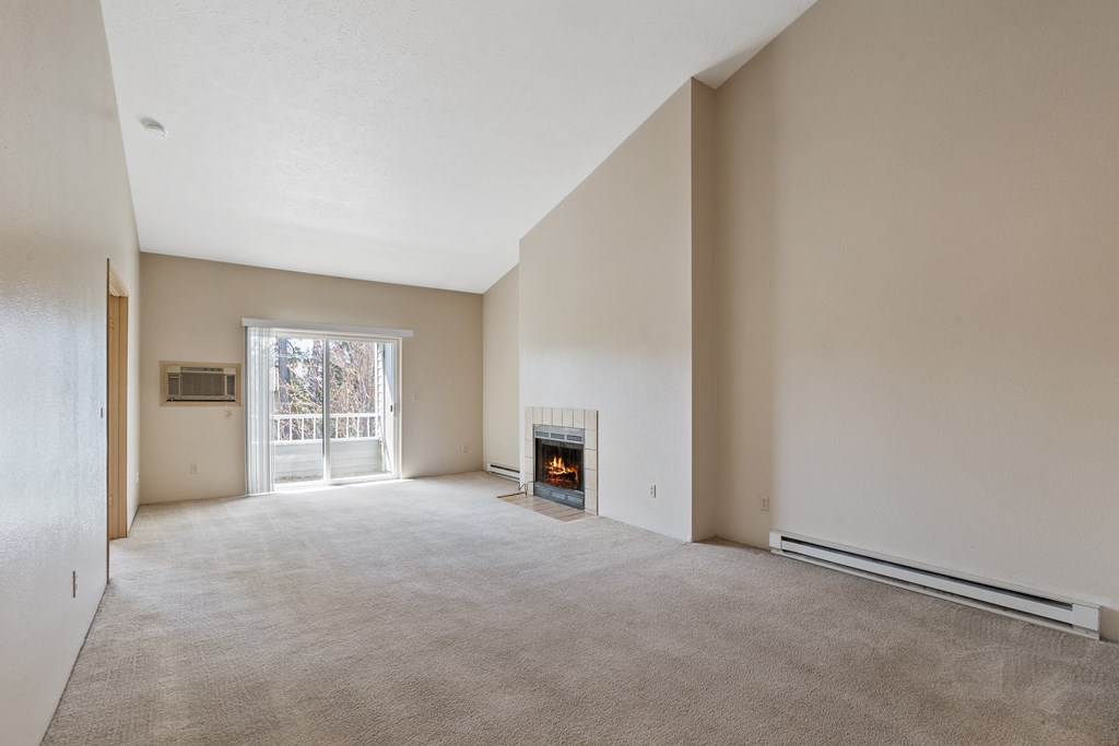 the living room of an empty house with a fireplace