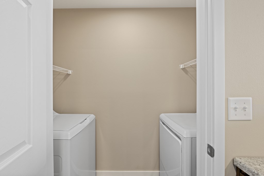 a small laundry room with two washes and a dryer