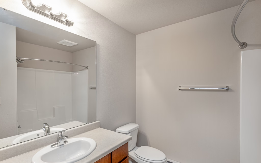 a bathroom with a sink toilet and a mirror