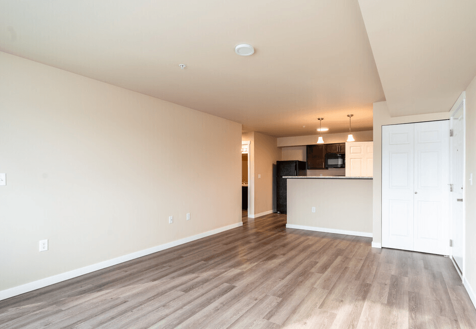 a living room and kitchen with wood floors