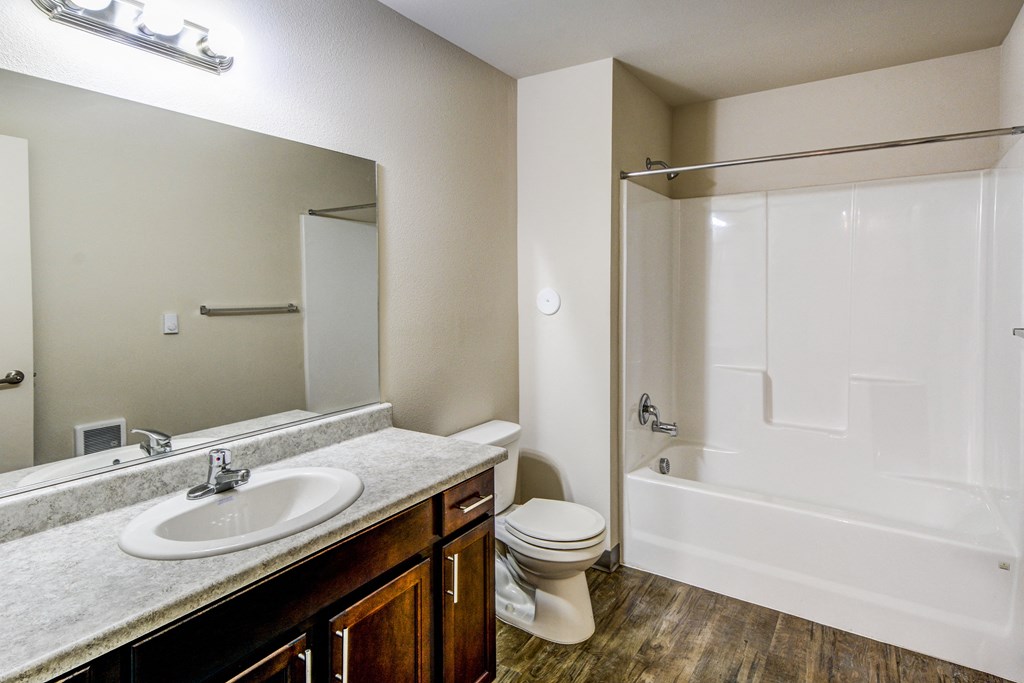 an empty bathroom with a sink toilet and shower