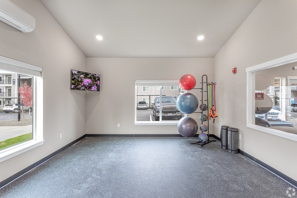 a room with a large window and balloons on the floor