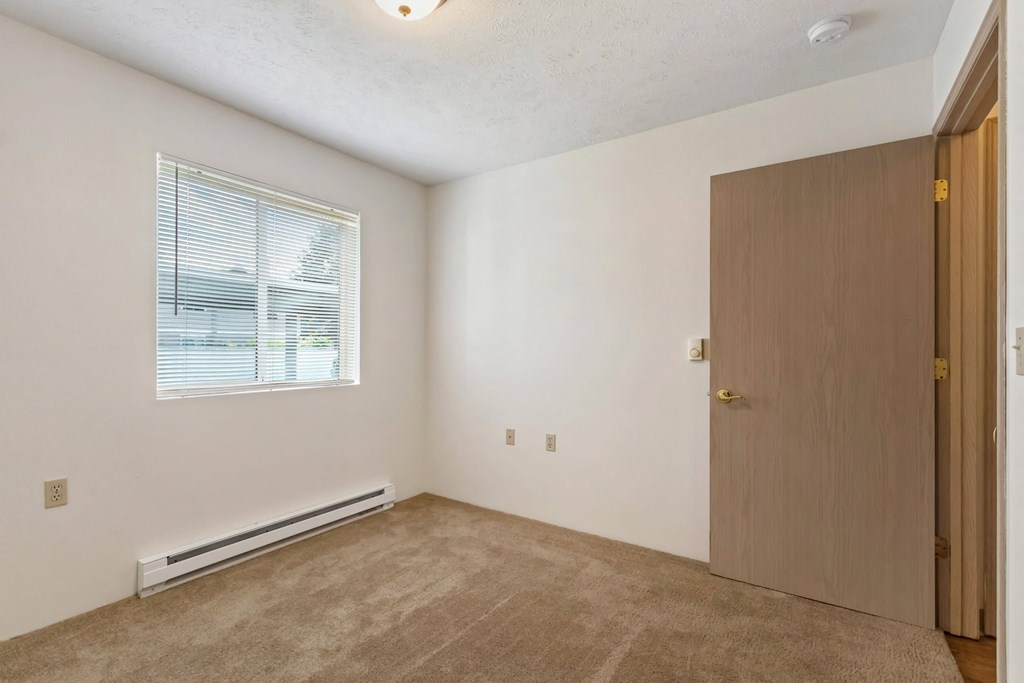 an empty room with a door and a window