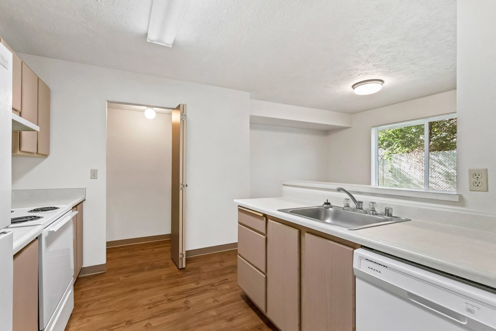 kitchen with white appliances and wood flooring