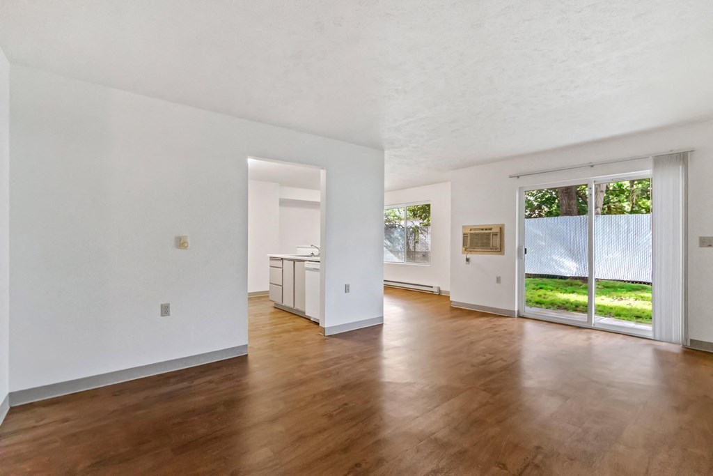 A room with wooden floors and white walls.