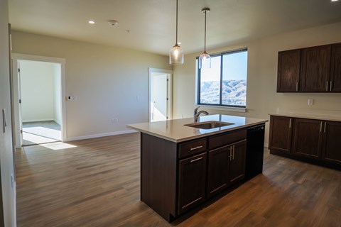 A kitchen with dark wood cabinets and a large island.