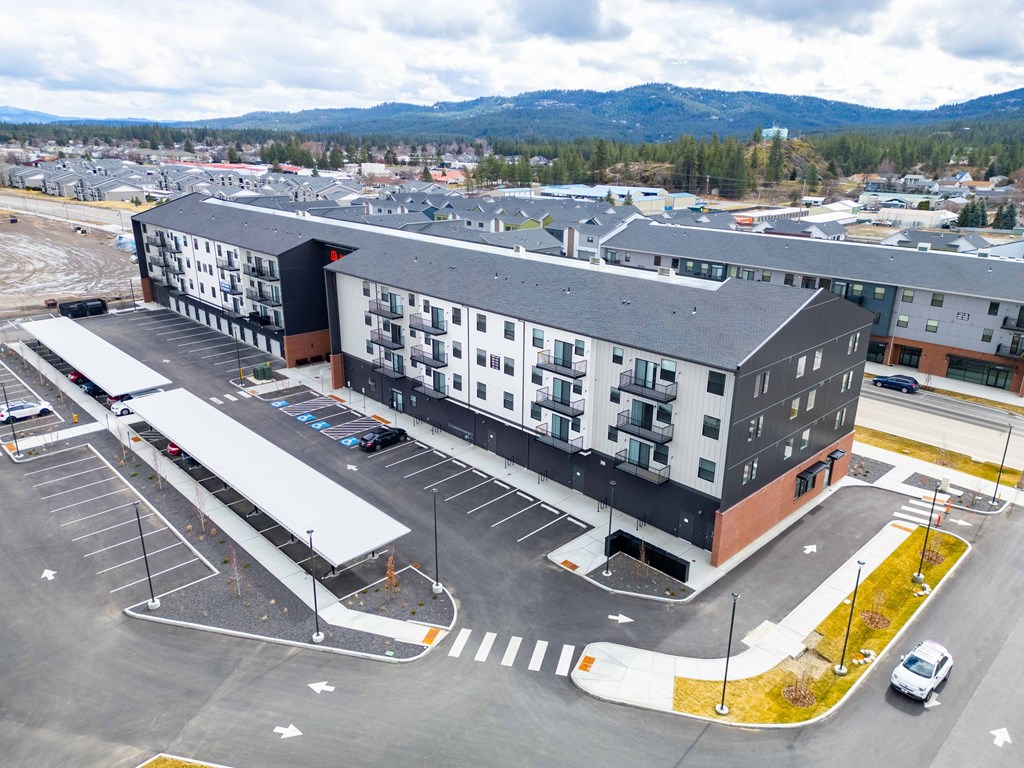 A large building with a parking lot in front of it.