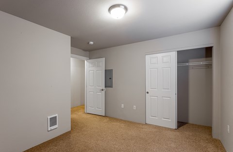 a bedroom with two closets and a door to a closet