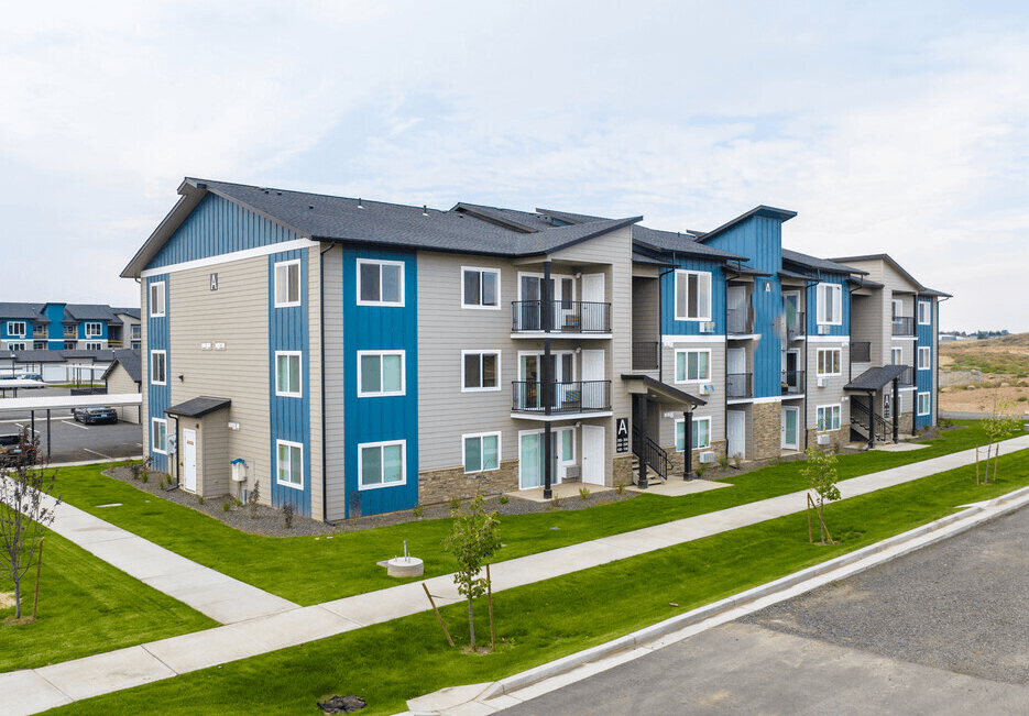 a row of new apartment buildings next to a street