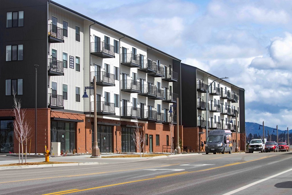 A large apartment building with balconies on the second floor.