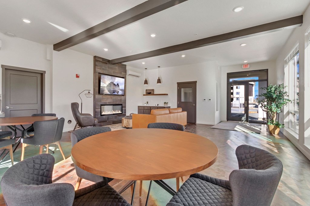 a living room with a table and chairs and a fireplace