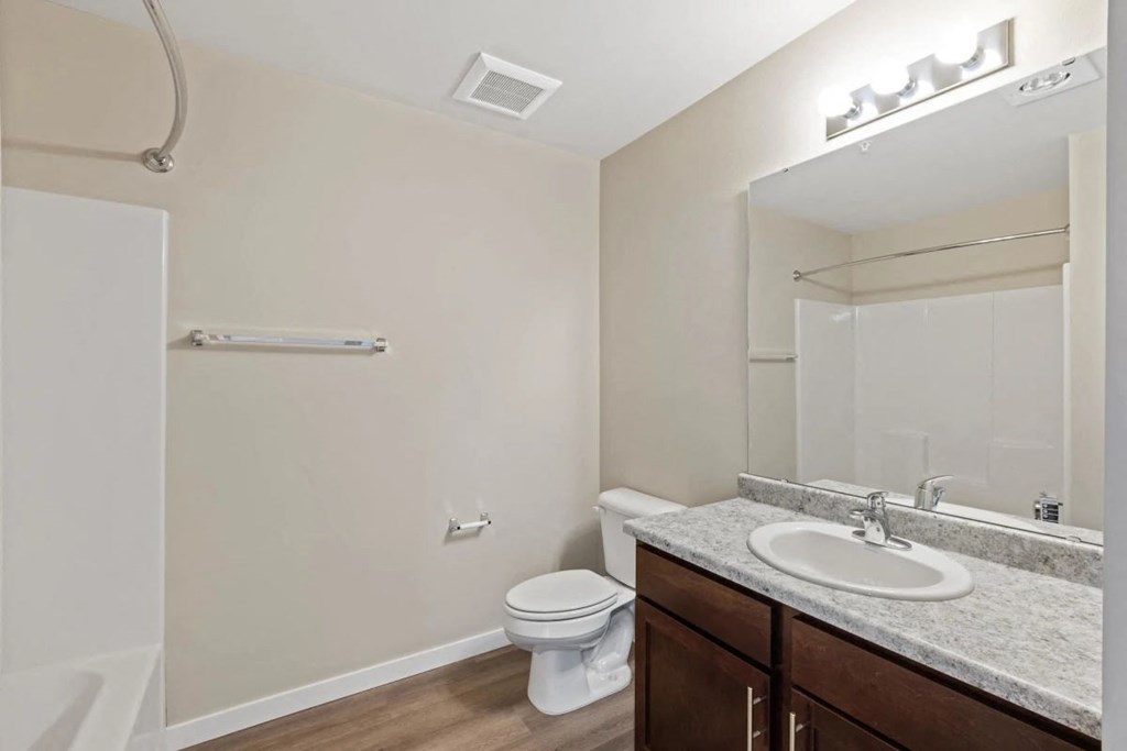a bathroom with a sink toilet and a mirror
