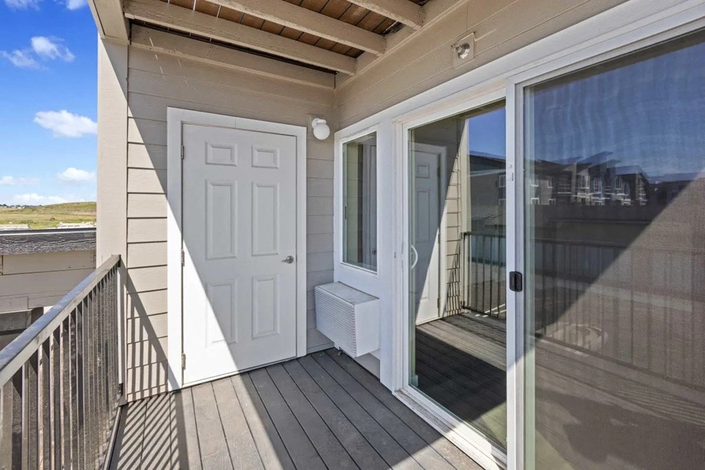 the door to the balcony is open to the patio