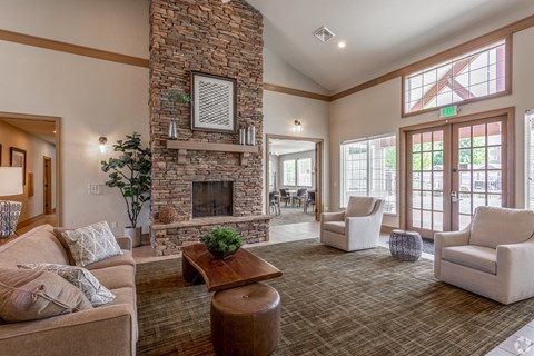 a living room with a stone fireplace and a couch