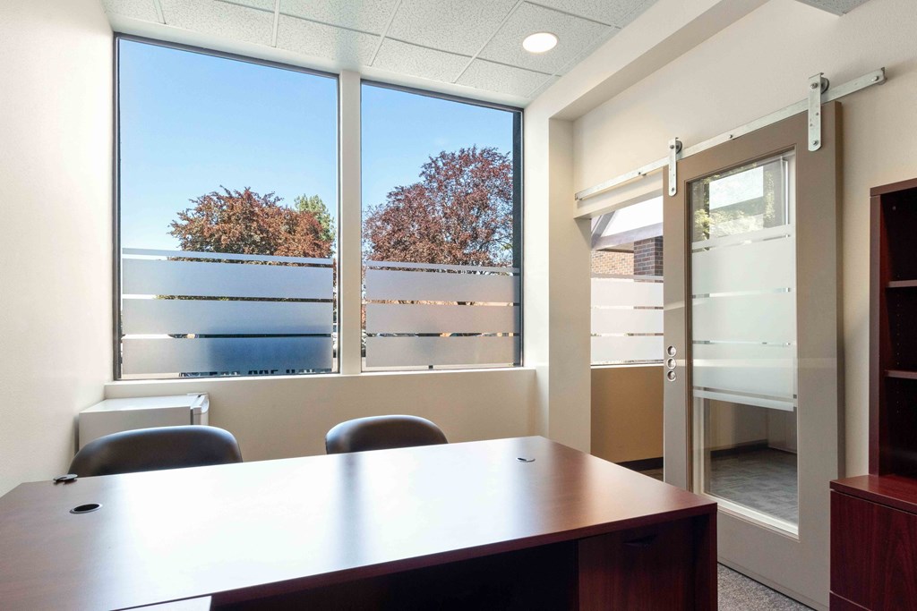 a office with a desk and a window