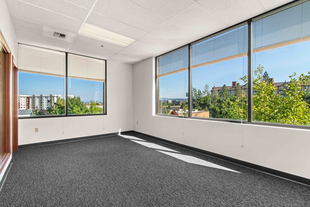 an empty office space with large windows and a city view
