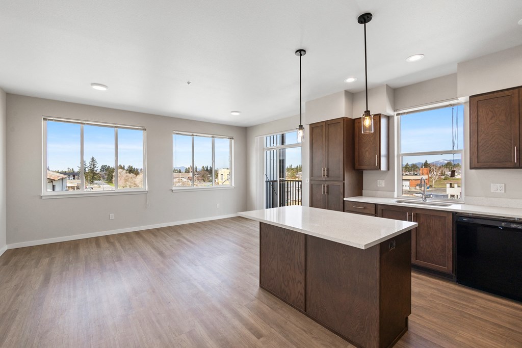 an open kitchen and living room with a large island