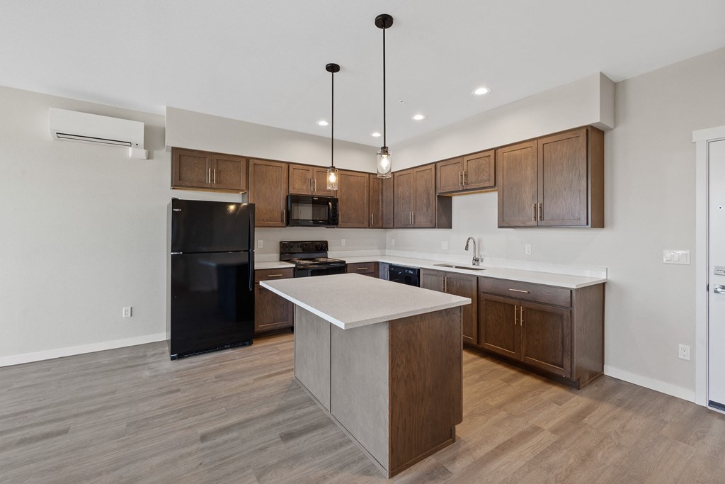 an empty kitchen with wooden cabinets and a white counter top