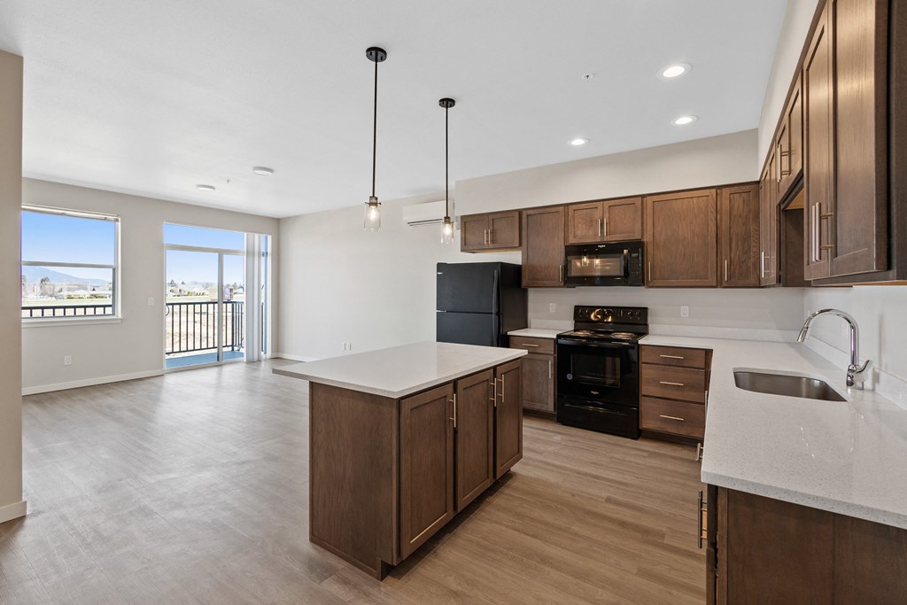 an empty kitchen with wooden cabinets and a white counter top