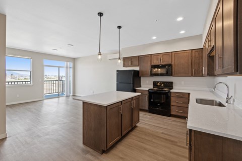 an empty kitchen with wooden cabinets and a white counter top