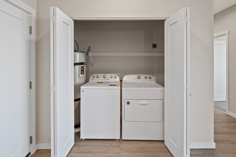 an empty laundry room with washer and a dryer