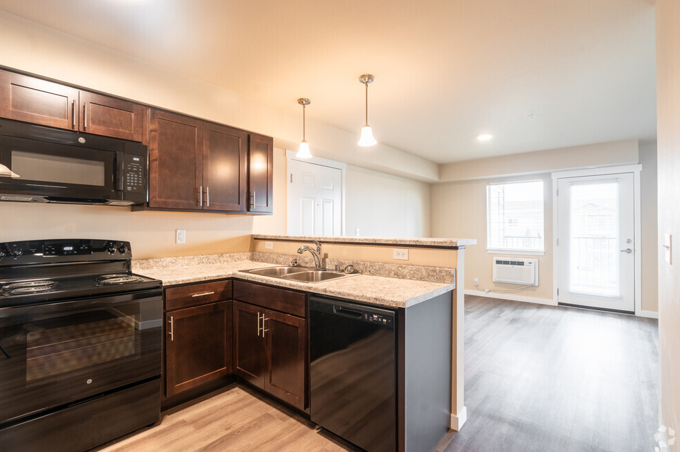 a kitchen with black appliances and granite counter tops