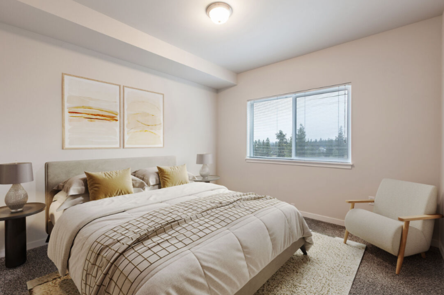 A bedroom with a large bed and a chair.