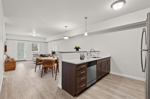 A modern kitchen with a dining table and chairs.