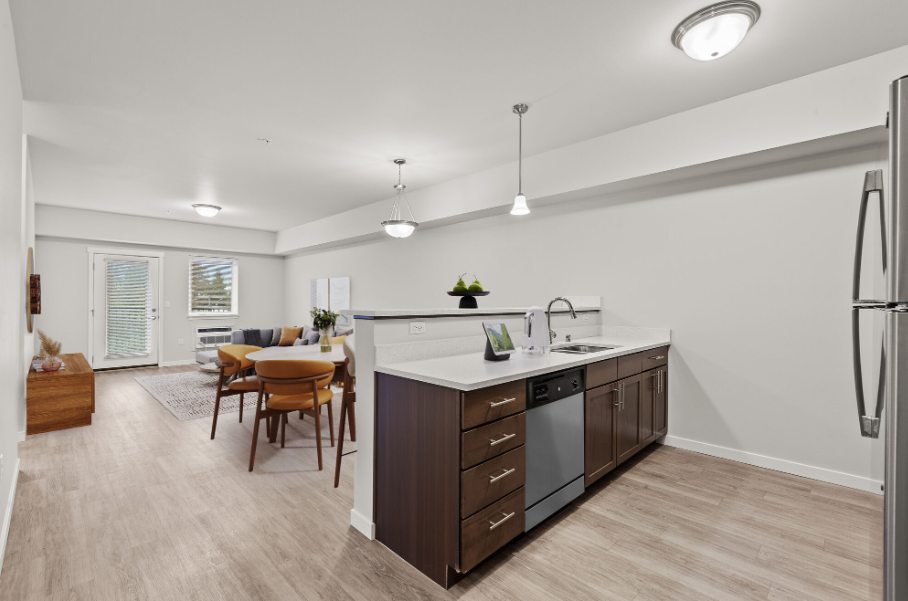 A modern kitchen with a dining table and chairs.