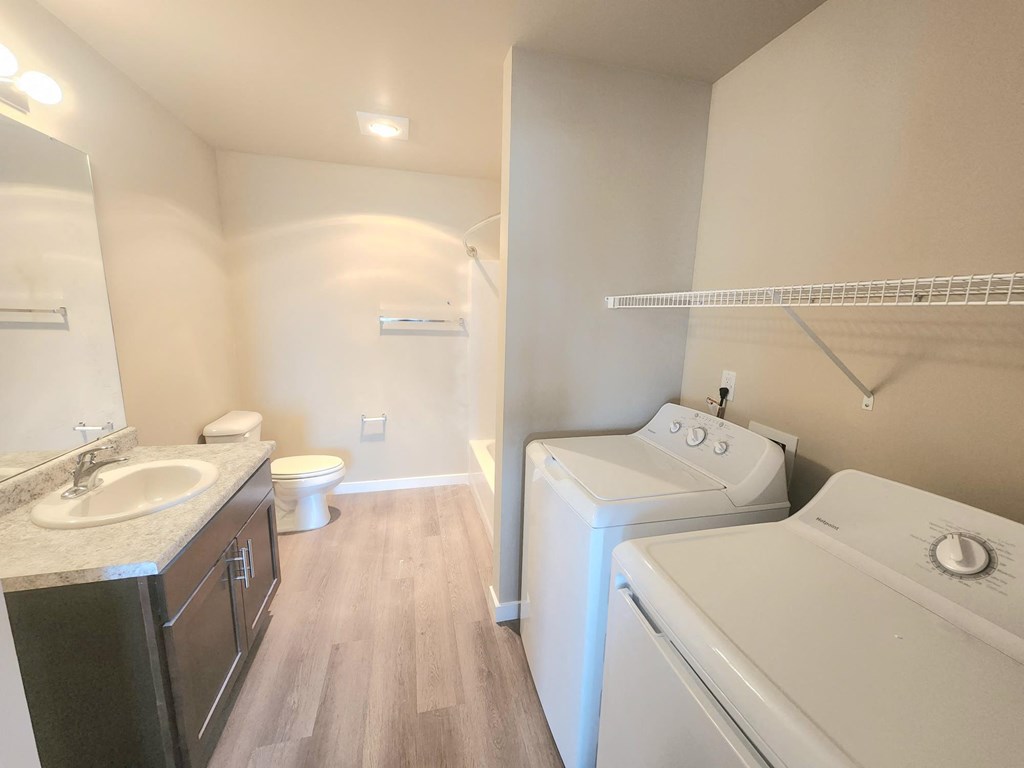 a laundry room with a washer and dryer and a sink