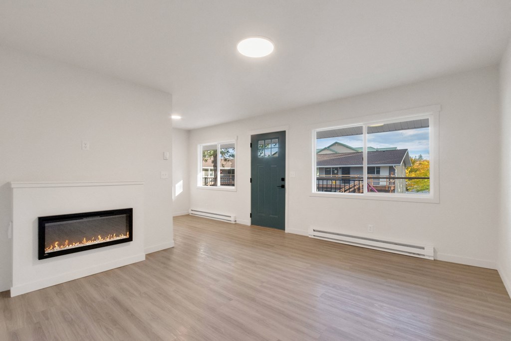 a living room with a fireplace and a window