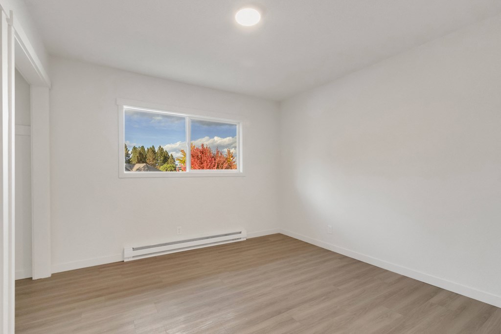 a living room with white walls and a window