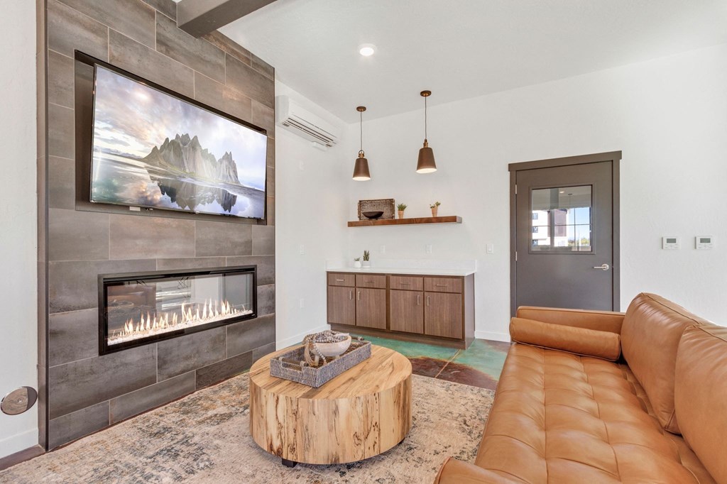 a living room with a fireplace and a television