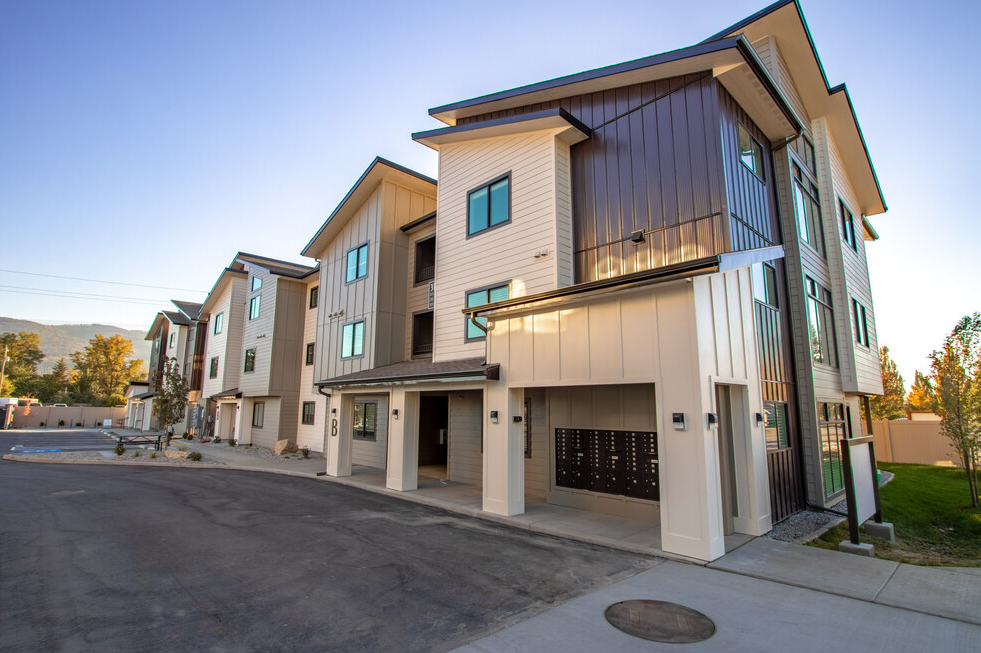 a row of town houses with a street in front of them