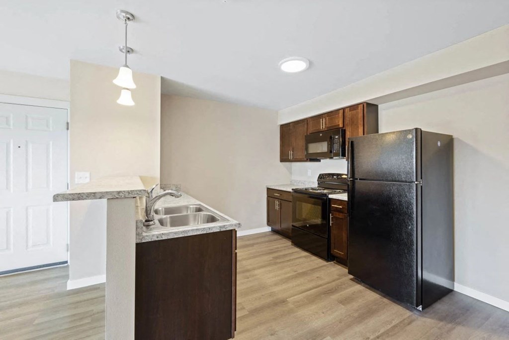 a kitchen with a refrigerator and a sink