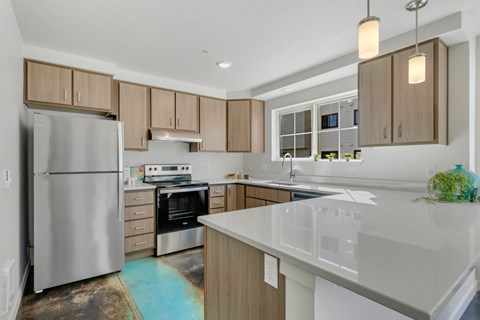 a kitchen with a large island and stainless steel appliances