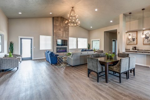 A modern living room with a dining area and a kitchen in the background.